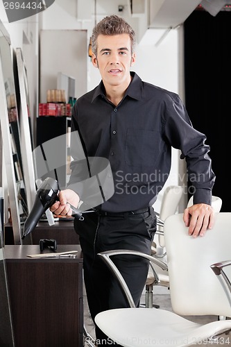 Image of Confident Male Hairstylist With Blower
