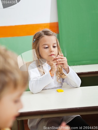 Image of Girl Molding Clay In Classroom