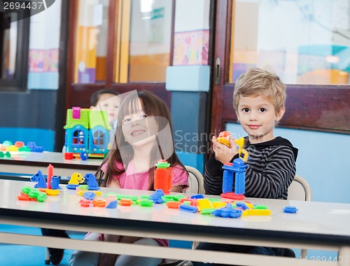 Image of Little Children Playing With Blocks In Preschool