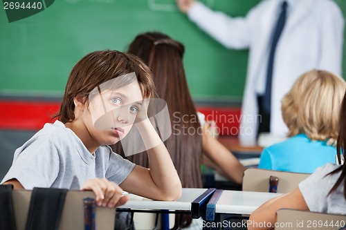 Image of Portrait Of Little Boy Leaning At Desk