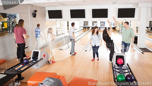 Image of Friends Playing in Bowling Alley