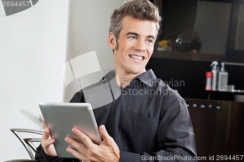 Image of Male Client With Digital Tablet In Salon