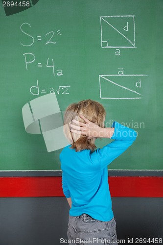 Image of Confused Little Boy Looking At Board