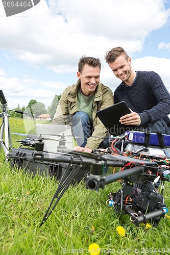 Image of Technicians Discussing Over Digital Tablet By UAV