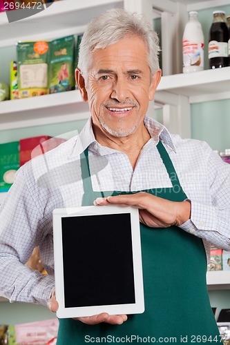 Image of Male Owner Showing Digital Tablet In Store