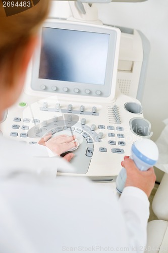 Image of Doctor Holding Ultrasound Equipment