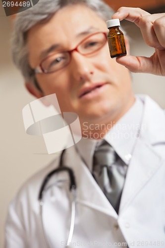 Image of Physician Holding Medicine Bottle