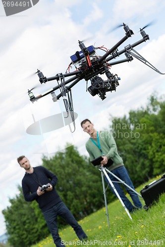 Image of Engineers Operating UAV Octocopter in Park