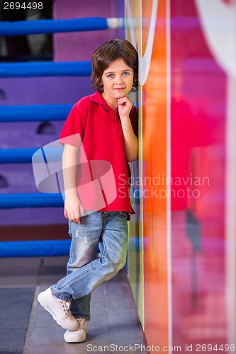 Image of Boy With Hand On Chin Leaning On Wall