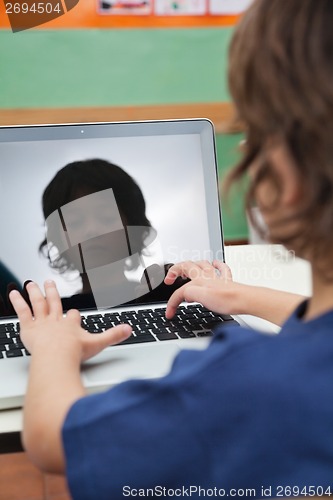 Image of Boy Using Laptop In Classroom