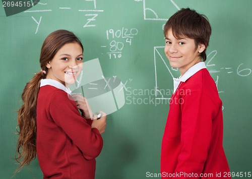 Image of Portrait Of Teenage School Students Standing Against Board