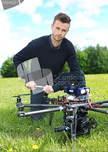 Image of Technician Fixing Propeller Of UAV Octocopter