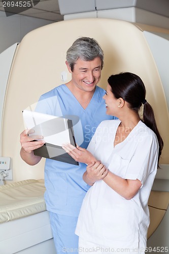 Image of Happy Technicians Holding Clipboard