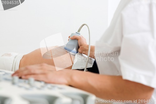Image of Doctor Examining Pregnant Belly By Ultrasonic Scan