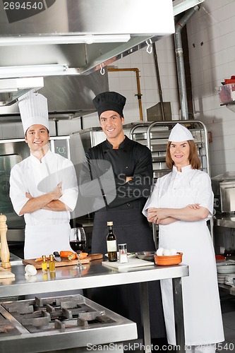 Image of Team Of Confident Chefs In Industrial Kitchen