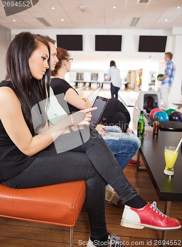 Image of Woman Using Digital Tablet in Bowling Club