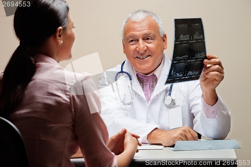 Image of Radiologist Showing X-ray To Patient