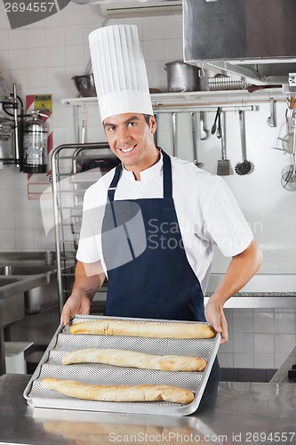 Image of Male Chef Presenting Baked Bread Loafs