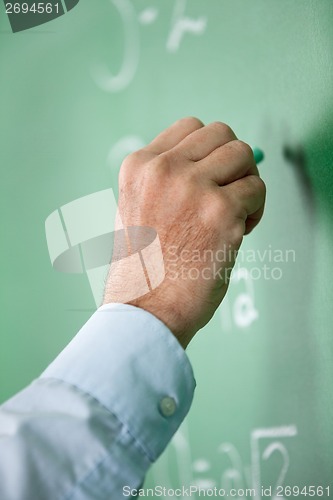 Image of Male Teacher'S Hand Writing On Greenboard