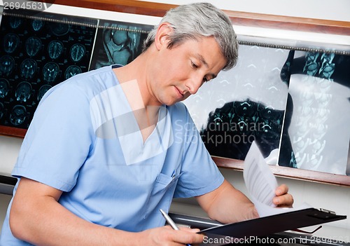 Image of Medical Professional Going Through Document