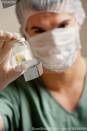 Image of Surgeon Holding Pill Bottle