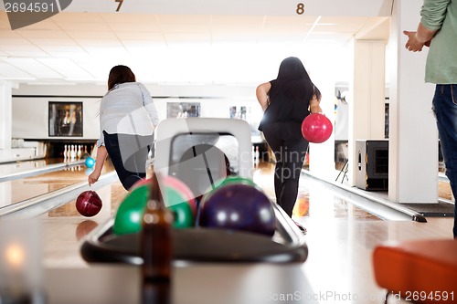 Image of Women Playing in Bowling Alley