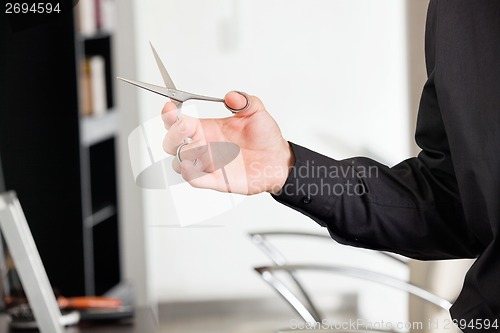 Image of Male Hairstylist's Hand Holding Scissors