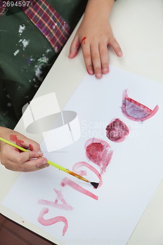 Image of Boy Painting Name On Paper In Art Class