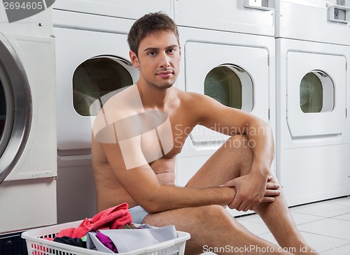 Image of Semi Nude Man With Laundry Basket