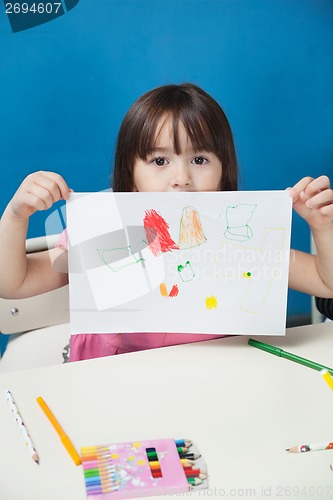 Image of Girl Showing Drawing Paper In Classroom