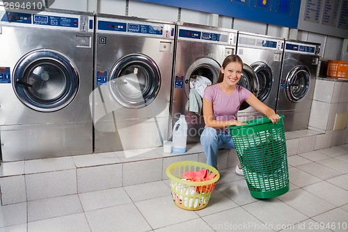 Image of Woman With Baskets Of Clothes At Laundry