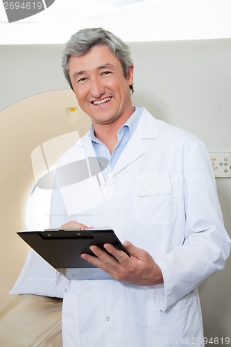 Image of Happy Doctor Holding Clipboard