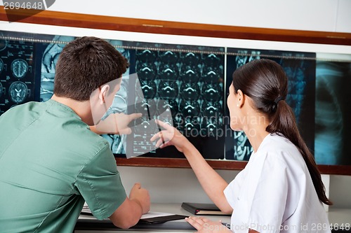 Image of Medical Technicians Pointing At MRI X-ray