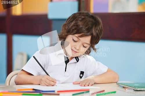 Image of Boy With Sketch Pen Drawing In Kindergarten