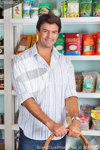 Image of Portrait Of Man With Basket In Grocery Store