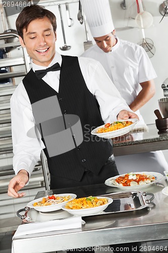 Image of Waiter Holding Pasta Dish