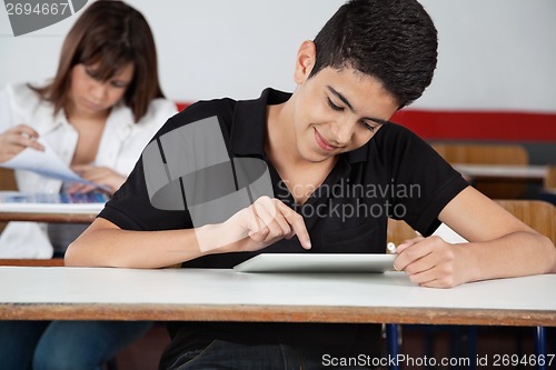 Image of High School Student Using Digital Tablet At Desk