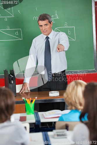 Image of Mature Teacher Pointing At Students