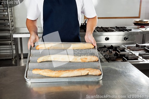 Image of Male Chef Presenting Bread Loafs