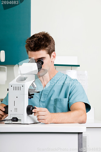 Image of Male Researcher Using Microscope In Laboratory