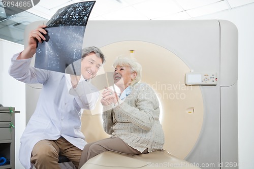 Image of Radiologist With Patient Looking At CT Scan Results