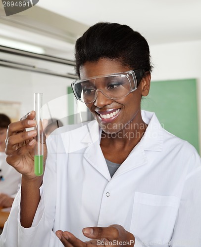 Image of Happy Teacher Looking At Chemical Solution