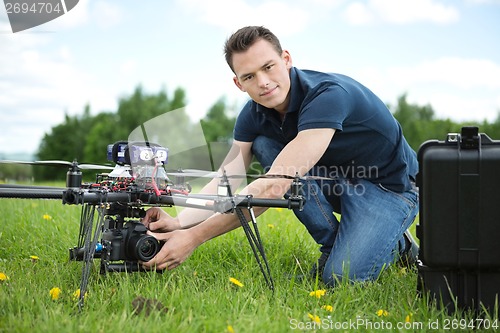 Image of Engineer Setting Camera On Photography Drone