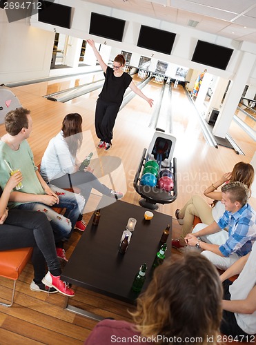 Image of Friends Looking At Woman Dancing in Bowling Club