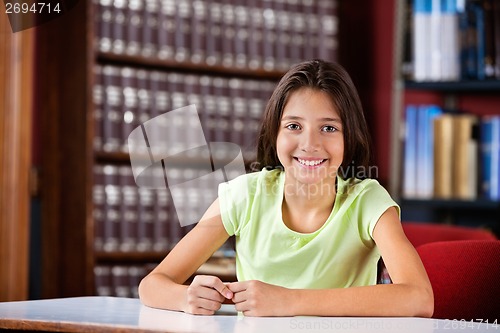 Image of Happy Schoolgirl Sitting In Library