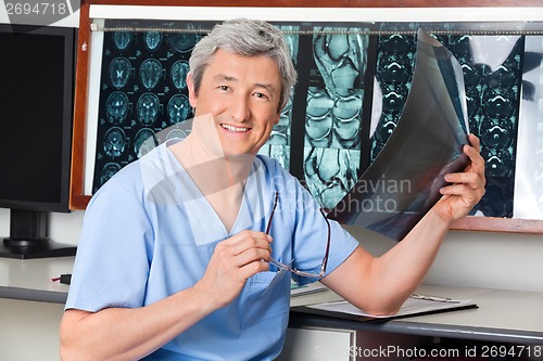 Image of Happy Radiologist Holding X-ray