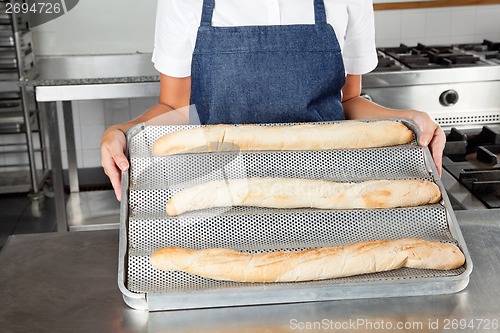 Image of Female Chef Presenting Baked Loafs