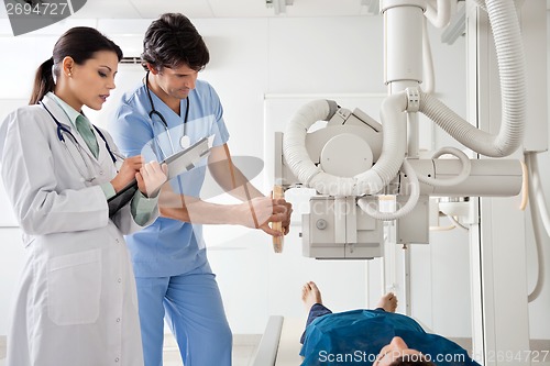 Image of Radiologists Performing X-ray On Patient