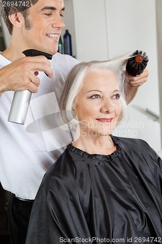 Image of Hairstylist Setting Up Woman's Hair