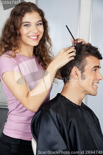 Image of Happy Female Hairdresser Cutting Client's Hair